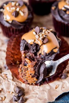 chocolate cupcakes with peanut butter frosting and sprinkles on top