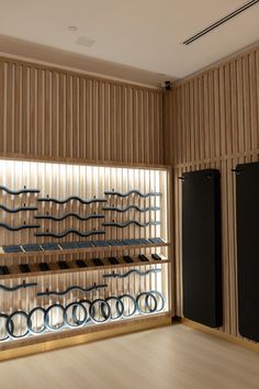 a room with wooden walls and shelves filled with metal objects