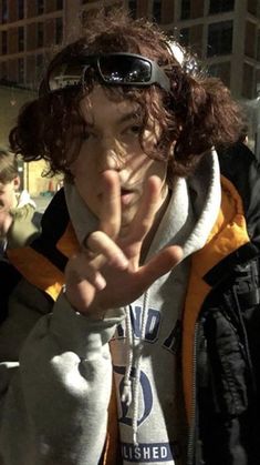 a woman making the vulcan sign with her fingers