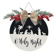 a black and white ornament with a nativity scene hanging from it's side