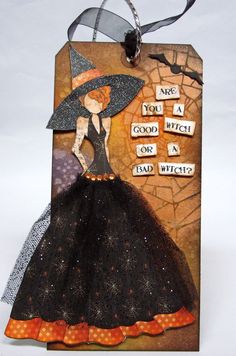 a halloween card with an image of a woman in a black dress and witch hat