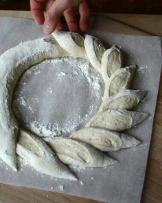 a person is making bread on a table