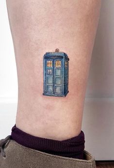 a small blue tardish tattoo on the ankle