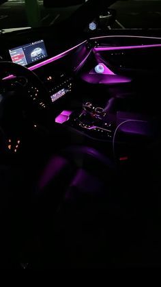 the interior of a car is lit up with purple lights