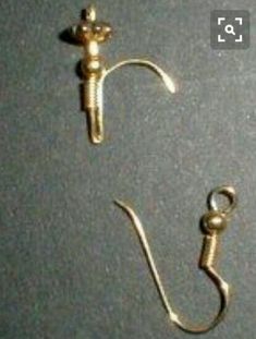 two metal hooks and a hook on a gray surface with the word love written below it