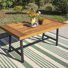 a wooden table sitting on top of a grass covered field