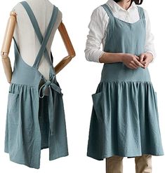 two mannequins dressed in blue aprons and overalls, one is standing next to the other