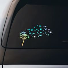 a dandelion sticker on the side of a car