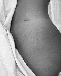 a black and white photo of a woman's stomach with the words i love you written on it