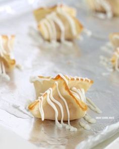 some kind of pastry with white icing on it's edges sitting on a baking sheet