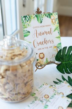 an animal cracker is on the table next to a jar of cookies and leaves