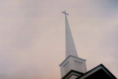 a church steeple with a cross on top