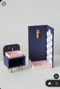 an open box with a sink in it next to a small wooden stool and shelf