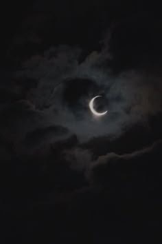 the moon is visible in the cloudy sky during a partial solar eclipse, as seen from earth's west coast