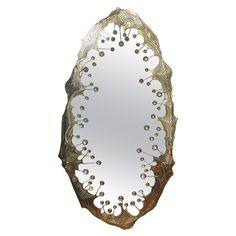 an ornate mirror is shown against a white background and has gold trimmings on the edges