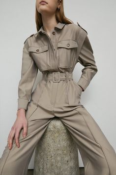 A tailored jumpsuit designed with a collared neckline, long sleeves, patch pockets and matching belt. Ideal for one-step styling. Jumpsuit Work Outfit, Utility Wear, Khaki Jumpsuit, Beige Jumpsuit, Balance Life, Jumpsuit Winter, Brown Jumpsuits, Tailored Jumpsuit, Winter Jumpsuit