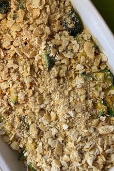 a casserole dish with broccoli and crumbs in it