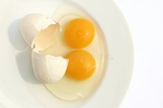 three eggs in a white bowl with one broken egg on the side royalty images and stock photos