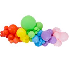 a bunch of balloons sitting on top of each other in the shape of a rainbow