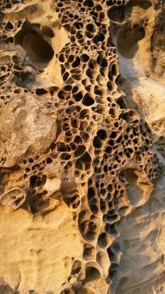 some rocks and sand with holes in them