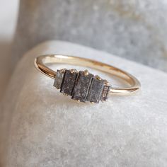 This unique vertical step ring features stunning salt and pepper baguette-cut diamonds in various shades of gray, set in a 14k yellow gold band. The diamonds are arranged in a striking vertical design, giving this ring a bold yet delicate geometric look. Perfect for an engagement, wedding, or anniversary, this natural, genuine diamond ring blends rustic vintage style with a modern twist, making it a truly unique and thoughtful gift for her. Measurements: * Gem Stones: 100% Natural Diamonds * Cen Salt And Pepper Baguette Ring, Baguette Cut Ring, Salt And Pepper Diamond Ring, Baguette Diamond Ring, Thoughtful Gifts For Her, Baguette Diamond Rings, Baguette Ring, Vertical Design, Baguette Cut Diamond