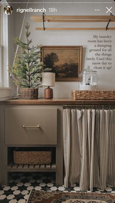 a room with a table, rug and pictures on the wall