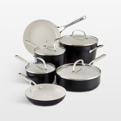 an assortment of pots and pans on a white background with the lids down,