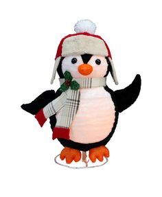 a stuffed penguin wearing a hat and scarf