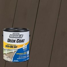 a can of deck coat sitting on top of a wooden fence