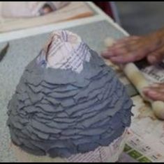 someone is making a sculpture out of clay