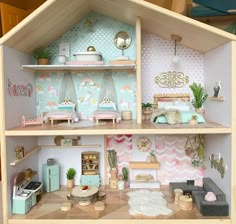 a doll house with furniture and accessories inside