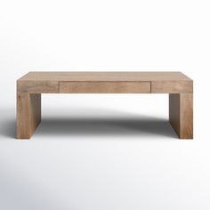 a wooden table sitting on top of a white floor covered in light colored wood furniture