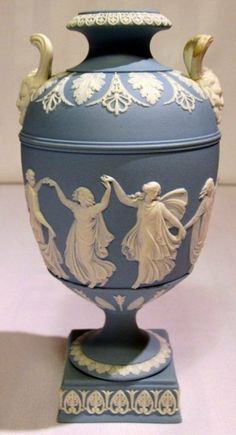 an ornate blue and white urn with figures on it