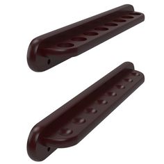 two brown plastic pegs with holes on them