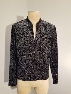 SHERI MARTIN NEW YORK CARDIGAN BLAZER JACKET  Black velvet with metallic silver glitter swirls  Built in shoulder pads Frog closure  Size 14 In excellent, vintage condition ✂ - - - Measurements laid flat: Pit to pit: 21" Waist: 19" Top to bottom: 23" Let's be friends https://www.facebook.com/TheGirlSaidYesVintage Glamorous Evening Cardigan For Winter, Glamorous Evening Winter Cardigan, Elegant Winter Party Cardigan, Holiday Party Long Sleeve Cardigan, Fitted Holiday Cardigan For Party, Elegant Winter Tops With Sequins, Fitted Long Sleeve Holiday Cardigan, Elegant Sequined Cardigan For Fall, Elegant Sequined Winter Tops