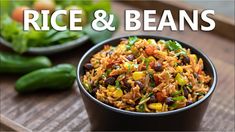 rice and beans in a black bowl on a wooden table