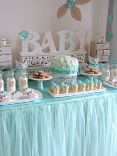 a table with many different desserts and candies on it's sides, including cake