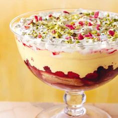 a dessert in a glass dish with toppings on top, ready to be eaten