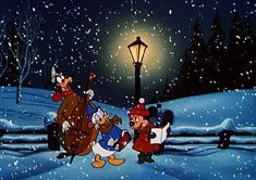 goofy and donald in the snow at night with a street light behind them, all dressed up for christmas