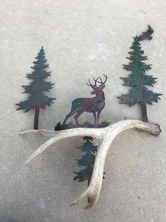 some metal deer and trees on the ground