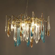 a chandelier with many different colored glass pieces hanging from it's sides