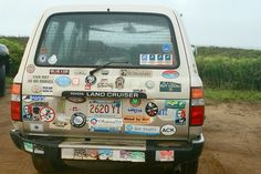 the back end of a vehicle with stickers on it