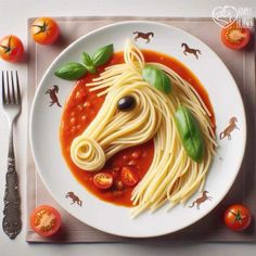 a white plate topped with spaghetti and a horse head made out of tomato slices on top of it