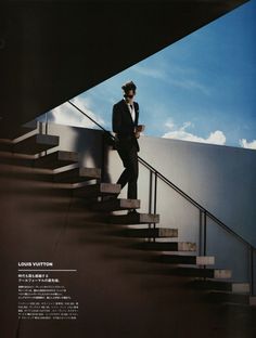 a man in a suit is standing on the stairs