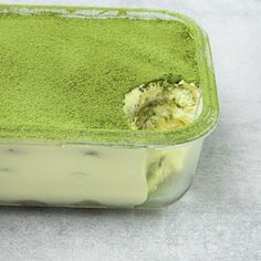 a green cake in a glass dish on a table