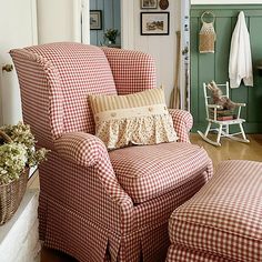 a red and white checkered chair with matching footstools in a living room