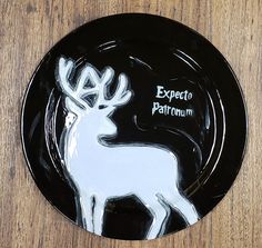 a black and white plate with an image of a deer in the center that says expect to parfuum on it