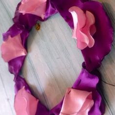 a purple and pink wreath made out of fabric