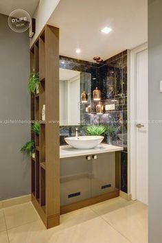 a bathroom with a sink, mirror and shelves on the wall next to each other