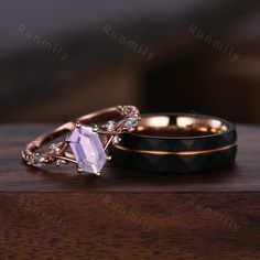 two wedding rings sitting on top of a wooden table next to each other with diamond accents